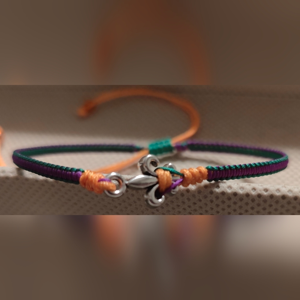 Handmade Adjustable Macrame bracelet Purple, green, & gold Fluer-De-Lis charm.